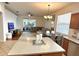 Open-concept living room with a view of the patio, a dining table, and an island at 4745 Trout River Xing, Ellenton, FL 34222