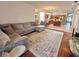 Open-concept living room and kitchen featuring a comfortable sofa, and a view into the kitchen at 4745 Trout River Xing, Ellenton, FL 34222