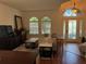 Sunlit living room boasts hardwood floors, large arched windows, and a stylish seating arrangement at 4745 Trout River Xing, Ellenton, FL 34222