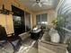 Cozy covered patio with comfortable seating, perfect for relaxing and enjoying the outdoors at 4745 Trout River Xing, Ellenton, FL 34222
