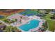 Aerial view of the Community pool with lounge chairs, tennis courts, and playground at 4745 Trout River Xing, Ellenton, FL 34222