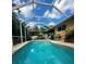 Backyard view of the inviting screened-in pool with clear blue water and comfortable lounge seating at 4745 Trout River Xing, Ellenton, FL 34222