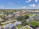 Overhead view of the home's location with nearby commercial spaces and community features under sunny skies at 4911 Bartelt Rd, Holiday, FL 34690