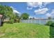 Spacious backyard with privacy fence and mature landscaping, offering a serene outdoor space at 4911 Bartelt Rd, Holiday, FL 34690
