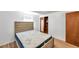 Bright bedroom features wood laminate flooring and a neutral color scheme with a bed at 4911 Bartelt Rd, Holiday, FL 34690