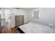 Bright bedroom features wood-look floors, a chest of drawers, and an entry door at 4911 Bartelt Rd, Holiday, FL 34690