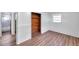 Bright bedroom features wood laminate flooring, closet with wood and a neutral color scheme at 4911 Bartelt Rd, Holiday, FL 34690