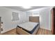 Comfortable bedroom with wood-look floors, two windows, and a mattress, offering a relaxing retreat at 4911 Bartelt Rd, Holiday, FL 34690