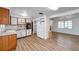 Well-lit kitchen opens to the living area, featuring a refrigerator, plenty of cabinet space, and modern flooring at 4911 Bartelt Rd, Holiday, FL 34690