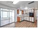 Functional kitchen with white cabinets and wood trim, offering a sink and an oven at 4911 Bartelt Rd, Holiday, FL 34690