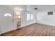 Bright living room showcases wood-look floors, and a front entry door, providing a welcoming atmosphere at 4911 Bartelt Rd, Holiday, FL 34690