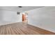 Spacious living room featuring wood-look floors and a large window offering plenty of natural light at 4911 Bartelt Rd, Holiday, FL 34690