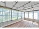 The sunroom includes lots of windows and wood-look flooring at 4911 Bartelt Rd, Holiday, FL 34690