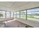Bright sunroom featuring multiple windows, creating a cozy and inviting space to relax and enjoy the outdoors at 4911 Bartelt Rd, Holiday, FL 34690