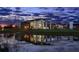 Stunning community clubhouse with modern design reflected in pond at dusk at 5033 Chapel Row Ave, Apollo Beach, FL 33572