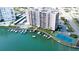 Aerial view showcasing the community's waterfront location with boat docks, tennis court, pool, and meticulous landscaping at 51 Island Way # 800, Clearwater Beach, FL 33767