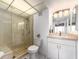 Bright bathroom featuring a glass-enclosed shower and a vanity with ample storage at 51 Island Way # 800, Clearwater Beach, FL 33767