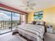 Bright bedroom with a patterned quilt, balcony access, and city views at 51 Island Way # 800, Clearwater Beach, FL 33767