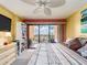 Comfortable bedroom featuring a ceiling fan, balcony, and built-in shelving at 51 Island Way # 800, Clearwater Beach, FL 33767