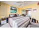 Cozy bedroom with a decorative painting, mirrored closet, and ceiling fan at 51 Island Way # 800, Clearwater Beach, FL 33767