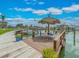 Scenic dock area with thatched umbrella, boats, and waterfront views for relaxing enjoyment at 51 Island Way # 800, Clearwater Beach, FL 33767
