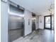 Bright interior shot of stainless steel elevators with modern overhead lighting, tiled floors, and neutral wall paint at 51 Island Way # 800, Clearwater Beach, FL 33767
