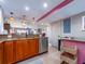 A kitchen featuring wooden cabinets, granite countertops, stainless steel appliances, and a bar-style counter at 51 Island Way # 800, Clearwater Beach, FL 33767