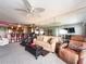 A cozy living room featuring carpet, ceiling fan, mirrored wall, and comfortable seating at 51 Island Way # 800, Clearwater Beach, FL 33767
