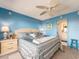 A bright main bedroom offers serene blue walls, a ceiling fan, and access to the ensuite at 51 Island Way # 800, Clearwater Beach, FL 33767
