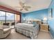 Main bedroom with blue walls, a ceiling fan, balcony access, and waterfront view at 51 Island Way # 800, Clearwater Beach, FL 33767