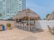 Enjoy outdoor entertaining at the bar area with TV, seating, and a tropical thatched roof at 51 Island Way # 800, Clearwater Beach, FL 33767
