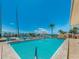 Community pool with palm trees, marina view, and clear blue sky at 51 Island Way # 800, Clearwater Beach, FL 33767