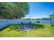 Brick fire pit and adirondack chairs in the backyard with a view of the lake at 5102 Pheasant Woods Dr, Lutz, FL 33558