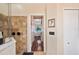 Bathroom featuring tiled shower, hardwood floors, and a doorway leading to a sunlit bedroom at 5102 Pheasant Woods Dr, Lutz, FL 33558