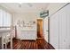 Neutral-toned bedroom showcasing wood floors, ample closet space, and a bunk bed with a dresser at 5102 Pheasant Woods Dr, Lutz, FL 33558
