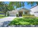 Well-maintained single-story home with lush front lawn, two-car garage, and walkway at 5102 Pheasant Woods Dr, Lutz, FL 33558