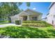 Charming single-story home with a manicured lawn and attached two-car garage at 5102 Pheasant Woods Dr, Lutz, FL 33558