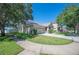Two-story home with two-car garage, manicured lawn, and proximity to tree-lined street at 5102 Pheasant Woods Dr, Lutz, FL 33558