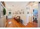 Bright foyer showcasing wood floors, a decorative bench and a gallery wall at 5102 Pheasant Woods Dr, Lutz, FL 33558