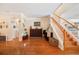 Charming foyer with hardwood floors, staircase, and arched doorways, creating an inviting entrance at 5102 Pheasant Woods Dr, Lutz, FL 33558