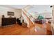 Inviting foyer featuring hardwood floors, staircase, and views into the living room with water view at 5102 Pheasant Woods Dr, Lutz, FL 33558