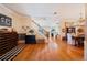 Open foyer with hardwood floors, staircase and decorative accents, leading to dining and kitchen at 5102 Pheasant Woods Dr, Lutz, FL 33558