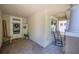 Covered porch with brick flooring, a rocking chair and a festive wreath on the front door at 5102 Pheasant Woods Dr, Lutz, FL 33558