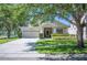 Charming single Gathering home with a well-maintained lawn and two car garage at 5102 Pheasant Woods Dr, Lutz, FL 33558