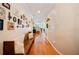 Hallway featuring wood floors, a hallway bench, and a decorative picture gallery at 5102 Pheasant Woods Dr, Lutz, FL 33558