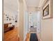 Charming hallway featuring wood floors and a bath sign over the doorway to a well decorated bathroom at 5102 Pheasant Woods Dr, Lutz, FL 33558