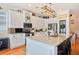 Well-lit kitchen featuring white cabinets, a breakfast bar, and stainless appliances at 5102 Pheasant Woods Dr, Lutz, FL 33558