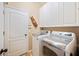 Well lit laundry room featuring a washer, dryer, shelving, and a tiled floor at 5102 Pheasant Woods Dr, Lutz, FL 33558