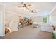 Bright living room with neutral carpet, ceiling fans, built-in shelving, and comfortable seating at 5102 Pheasant Woods Dr, Lutz, FL 33558