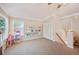 Bright living room with neutral carpet, shelving, large window and under stair access at 5102 Pheasant Woods Dr, Lutz, FL 33558